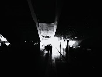 Silhouette of railroad station against sky at night