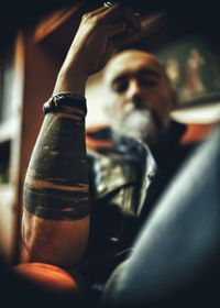 Close-up of man drinking beer in glass