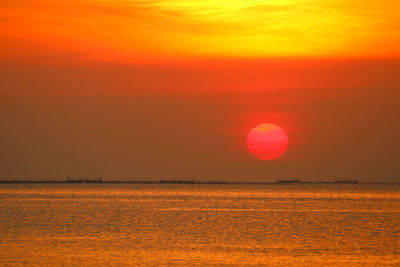 Scenic view of sea against romantic sky at sunset