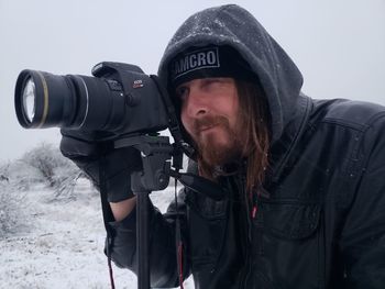 Close-up of man photographing in snow