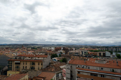 Cityscape against cloudy sky