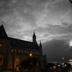 Low angle view of illuminated building against sky at dusk