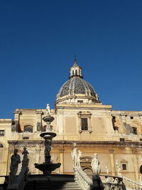 Low angle view of statue against blue sky