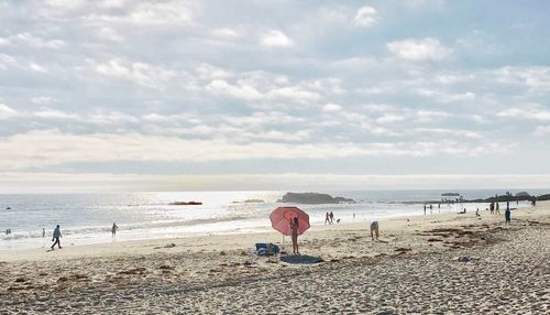 Man standing on beach against sky