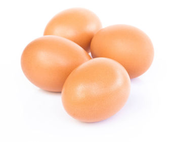 Close-up of eggs against white background