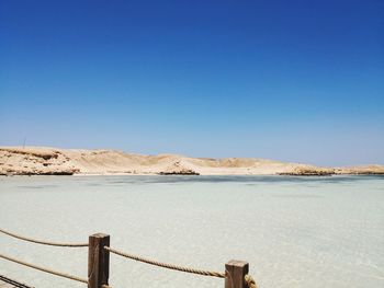 Scenic view of sea against clear blue sky