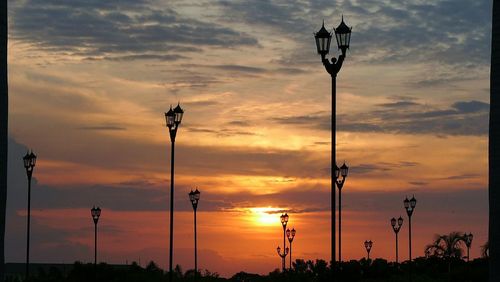 Silhouette street light against dramatic sky