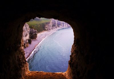 Sea and rock formations seen from window of cave