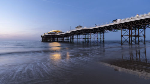 Pier on sea at sunset