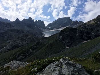 Scenic view of mountains against cloudy sky