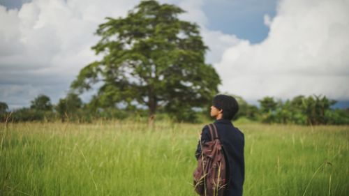 Man standing on field against sky