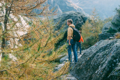 Woman standing on rock in forest