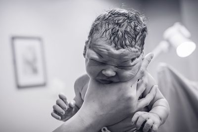 Close-up of hand holding newboen baby