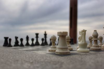 Close-up of chess pieces against sky