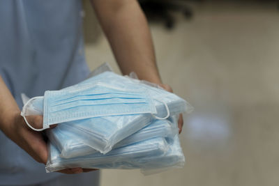 Midsection of woman holding paper