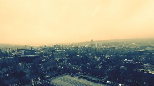 Aerial view of cityscape against sky during sunset