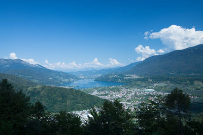 Scenic view of sea and mountains against blue sky