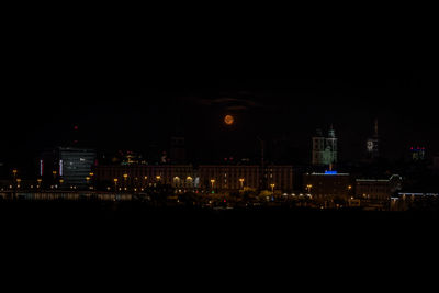 Illuminated buildings in city at night