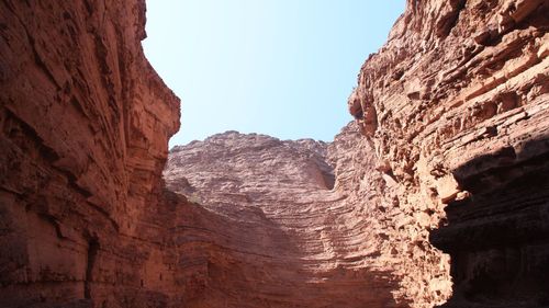 Low angle view of rock formations against sky