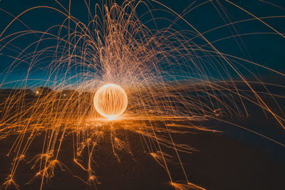 Close-up of illuminated fireworks against sky at night