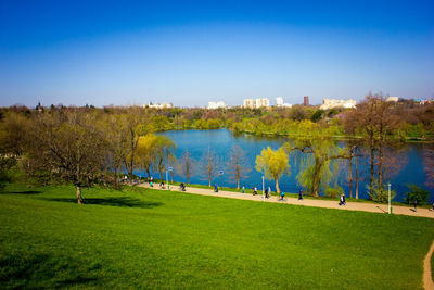 Scenic view of lake against clear blue sky