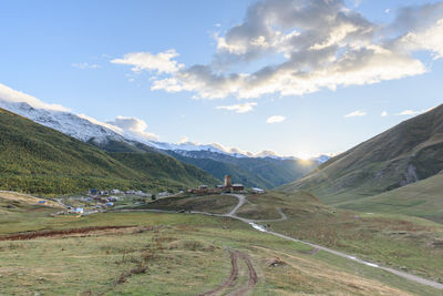 Scenic view of landscape and mountains against sky