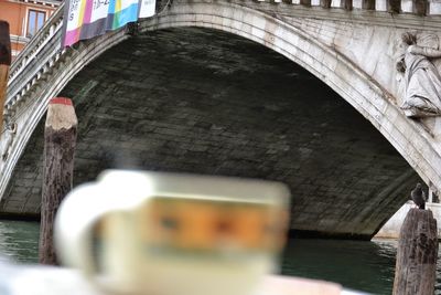 Arch bridge over canal amidst buildings