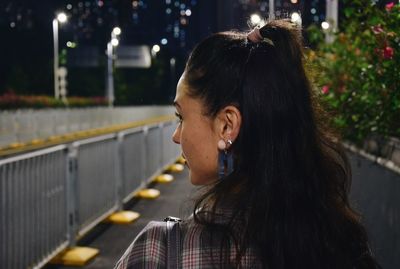 Portrait of woman looking away in city