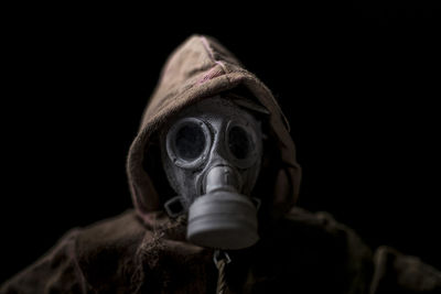 Close-up portrait of man in costume against black background