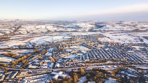 Aerial view of snow field against sky