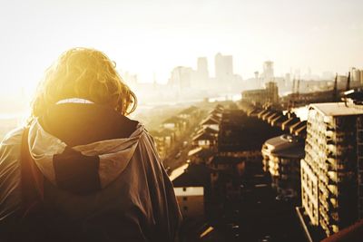 Rear view of man looking at cityscape