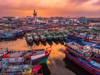 High angle view of boats moored at harbor during sunset