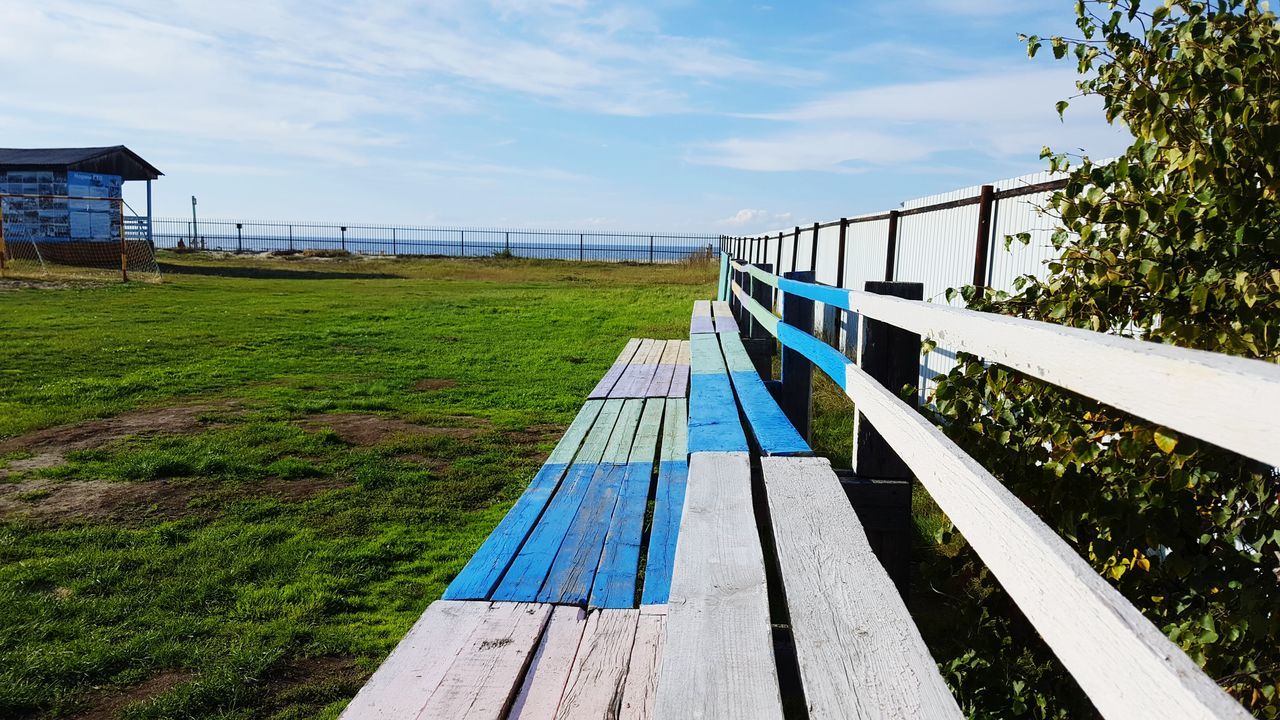 railing, sky, grass, tree, blue, water, day, outdoors, growth, footpath, tranquil scene, summer, nature, tranquility, pedestrian walkway, no people, scenics, bridge, the way forward, green color