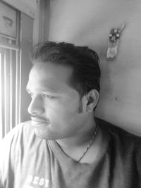 Portrait of young man looking away at home