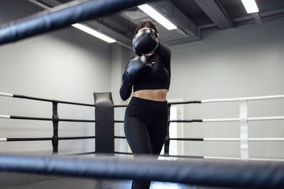 Side view of woman exercising in gym