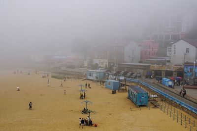 High angle view of crowd in city against sky
