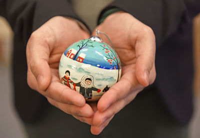 Midsection of man holding navigational compass