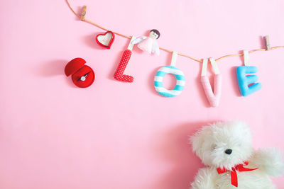 Close-up of toys against pink background