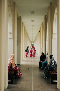 People sitting in corridor of building