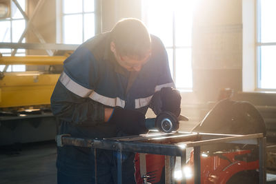 Side view of man working in factory