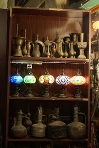 Close-up of various containers in shelf