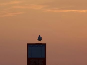 Low angle view of built structure at sunset