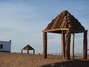 Lifeguard hut on beach against sky