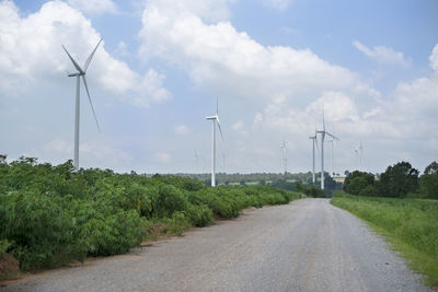 Road amidst field against sky