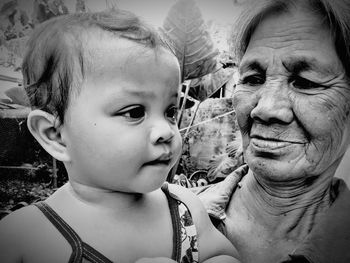 Woman carrying granddaughter