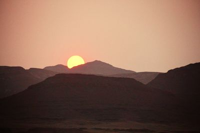 Scenic view of silhouette mountains against sky during sunset