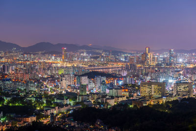 High angle view of illuminated buildings in city at night