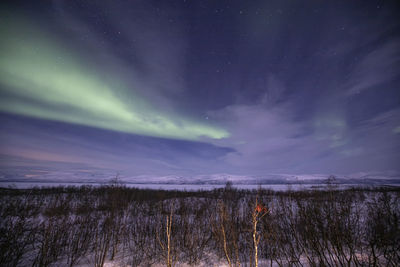 Scenic view of snowcapped landscape against sky at night