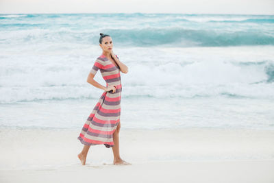 Woman standing on sand at beach