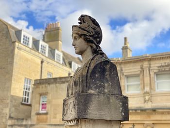 Low angle view of statue against building